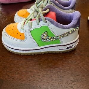 Nike Kids Sneakers with Orange, Green, and Purple Accents